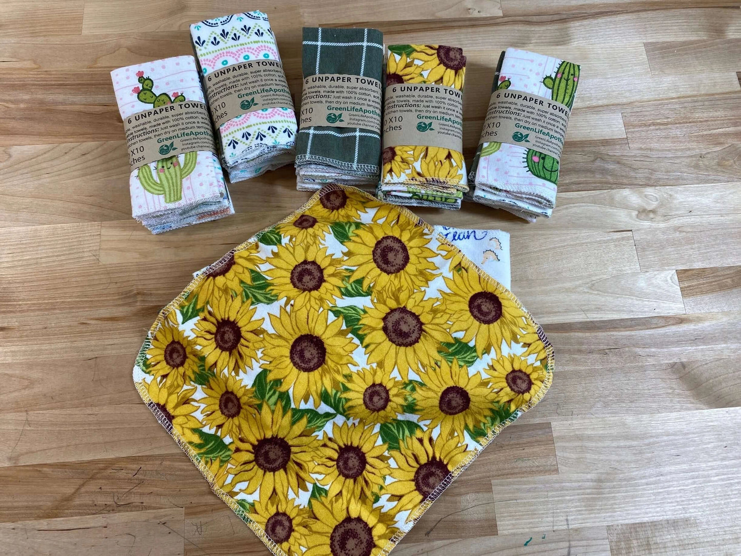 12 pack of GreenLife Apothecary Unpaper Towels with assorted designs including sunflowers and cacti, eco-friendly reusable towels.